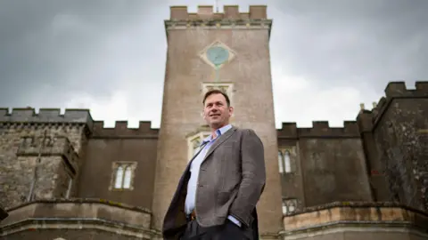 Shutterstock Charles Courtenay, the 19th Earl of Devon pictured at Powderham Castle, Devon where he resides.