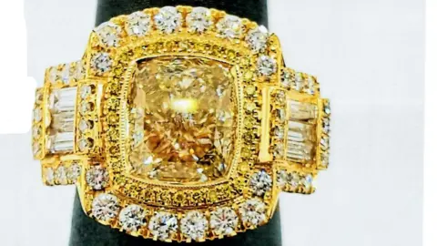 A gold and diamond ring on display 