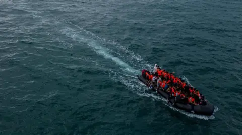 Reuters An aerial view shows a group of migrants on a dinghy in the English Channel