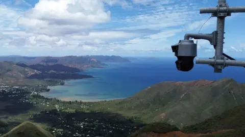 FireTracking A camera overlooks a mountainous regions near the sea in France.