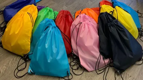 Sonal Mehta Drawstring bags of multi colours on the living room floor
