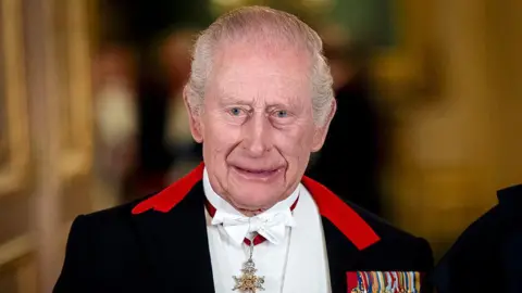 King Charles III standing for a formal photograph before a state banquet