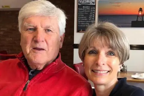 Supplied A man and woman smiling at the camera, sitting in a cafe.
