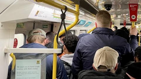 Passengers on a busy Tyne and Wear Metro train