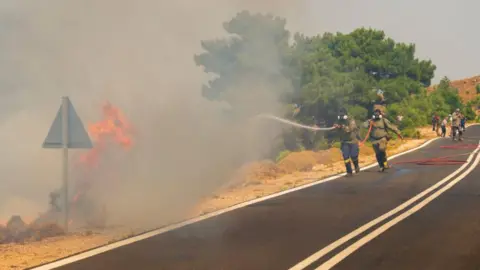 Reuters Firefighters respond to a wildfire on the island of Chios