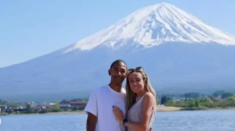 Michael Rimmer and Eilish McColgan smile while looking into the camera, shortly after getting engaged.