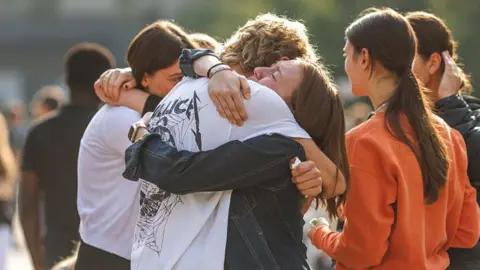 School children in Graz comfort each other