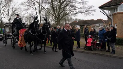 PA Media Members of the public line the street as Leah Croucher's hearse passes through on it's way to Crownhill Crematorium