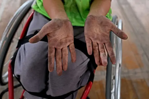 Hari Adivarekar A player shows her hands, dirty from handling the ball