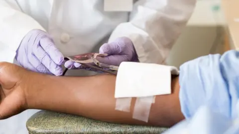 Getty Images Black man donating blood