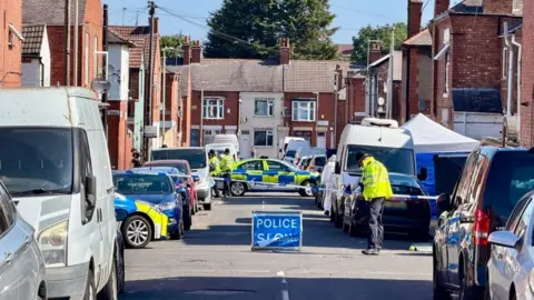 Police cordon in place with vehicles either side of the road