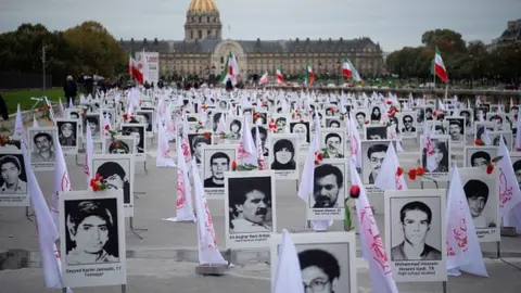 Getty Images Some 800 portraits of victims of the 1988 massacre displayed in Paris in 2019
