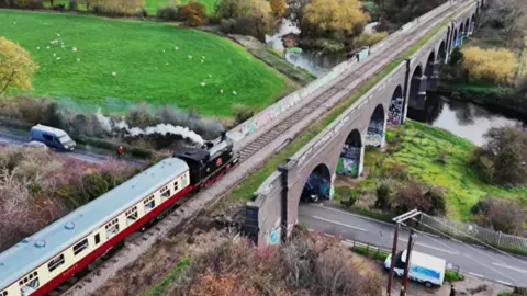A heritage train crosses Stanford Viaduct on the Great Central Railway Nottingham.