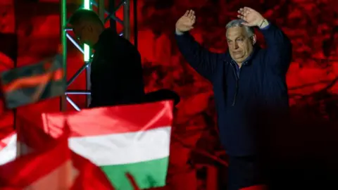 Reuters Viktor Orban addresses a crowd with a spectacular backdrop