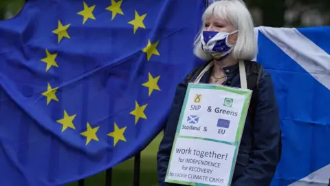 PA Media a campaigner outside Bute House as the agreement was announced