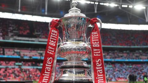 The Emirates FA Cup Trophy on display pitch side at Wembley Stadium ahead of the Emirates FA Cup Semi Final match between Coventry City and Manchester United at Wembley Stadium on April 21, 2024 in London, England