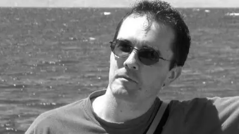 x.com/ch_capuano A black-and-white headshot of a man wearing sunglasses