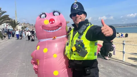 Andy's 52 in 52 Andy dressed as Mr Blobby for a marathon with a policeman