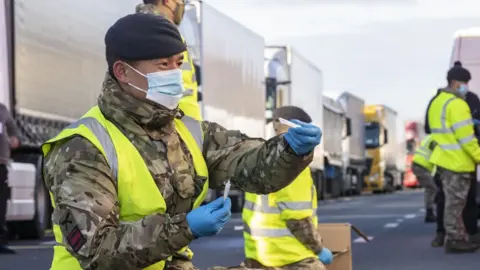 PA Media Military personnel helping test lorry drivers for Covid-19