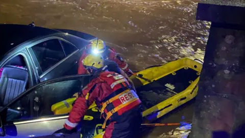 Warwickshire Fire and Rescue Service People being rescued from car