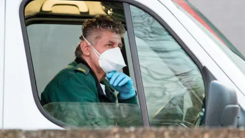 Getty Images ambulance driver in mask