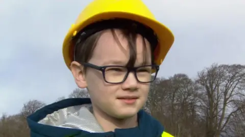 Wyatt in a high-vis jacket and hard hat