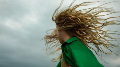 Woman with hair blowing in the wind