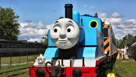 Getty Images A full scale model of the Thomas the Tank Engine. It is a blue train with an animate face on the front.