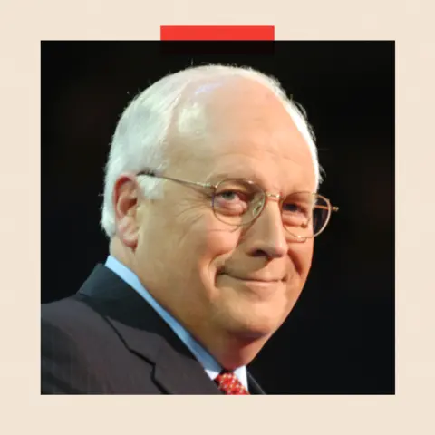 Getty Dick Cheney smiles, against a black background