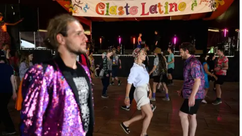  Leon Neal/Getty Images Festival-goers take part in a Tango dance lesson during day four of Glastonbury Festival