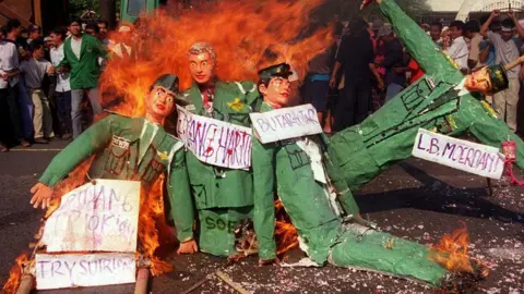 Getty Images Indonesian protestors burn effigies of former president Suharto, and several former military generals and officers in the streets of Jakarta 12 September 2000, whom they accuse of responsiblity in the 1984 massacre in the harbour area of Tanjung Priok in North Jakarta in which over 100 people may have been killed.