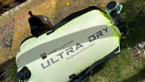 Sean Corcoran The watched attached to the yellow Open Water Ultra Dry Adventure floating device.