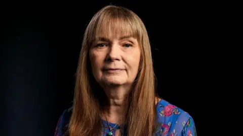  BBC/Keo Films A woman with long brown hair and a straight fringe. 