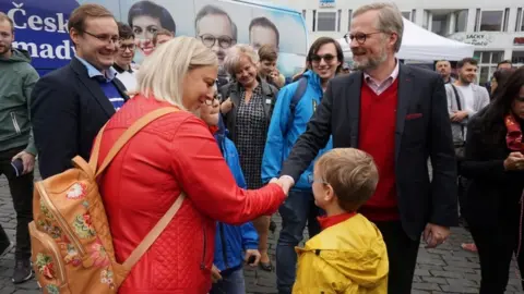 Reuters Petr Fiala, leader of the Civic Democratic Party and the Together coalition candidate for Czech prime minister, greets supporters during an election campaign rally in Usti nad Labem, Czech Republic, October 5, 2021.