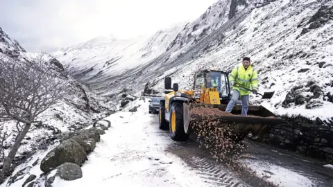 PA Wire A tractor clears snow from a road near Honister Slate Mine in the lake district, Cumbria, UK