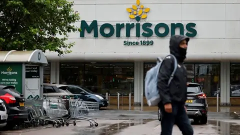 TOLGA AKMEN A shopper outside Morrisons