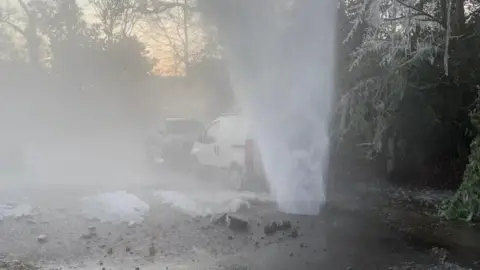 A burst water main spraying vertically