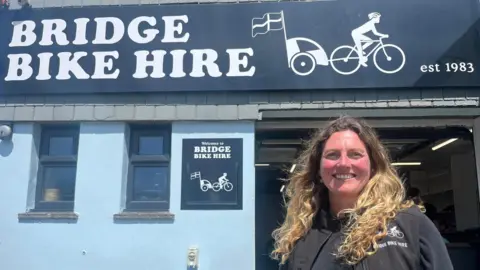 Kelly Arries stands outside the front of her Bridge Bike Hire business in Wadebridge.