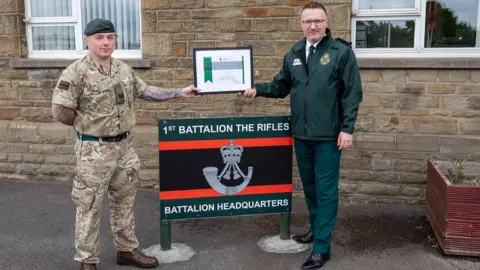 MOD Sjt Delahunty receives commendation certificate from Welsh Ambulance Service chief executive, Jason Killens