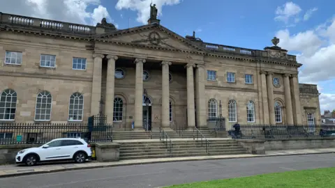Oliver Wright/BBC The outside of York Crown Court: a large and grand Georgian building with a set of steps leading up to the entrance.