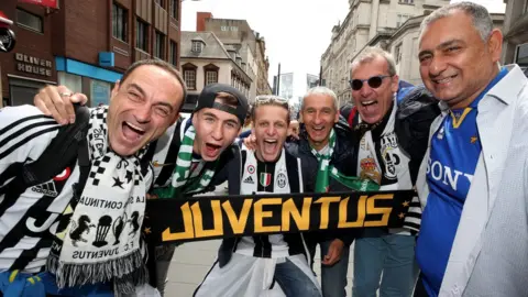 PA Juventus fans enjoy the atmosphere in Cardiff Bay