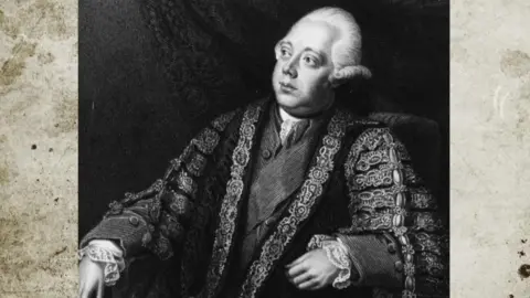 Hulton Archive via Getty Images A black and white portrait of a man with white hair wearing a ceremonial robe
