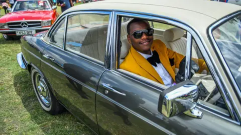Gerald Anderson/Getty Images A man in a car at the Africa Concours d'Elegance event at Nairobi racecourse, Kenya - Sunday 24 September 2023