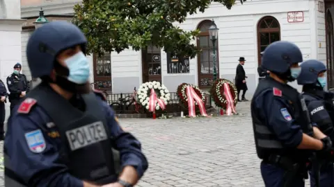 Reuters Police officers stand guard at the site of a wreath laying ceremony after a gun attack in Vienna,