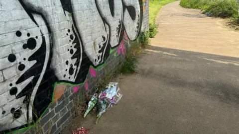Kate Bradbrook/BBC Floral tributes in Wellingborough