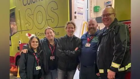 Open Road People standing in front of the SOS bus