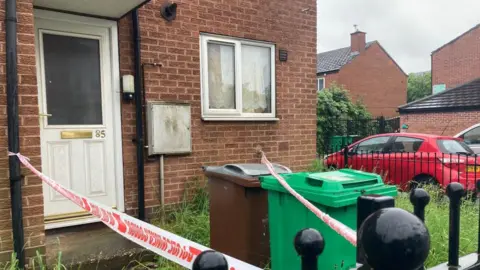 A house in Hartley Road in Radford with it's entrance cordoned off