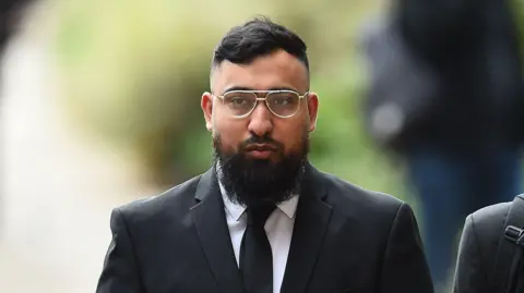 PA Media Muhammed Amaad arrives at Liverpool Crown Court, where along with Mohammed Fahir Amaaz they are charged in relation to an altercation with police officers at Manchester Airport's Terminal Two on July 23 2024. 