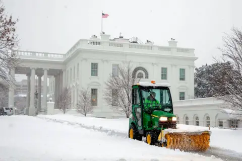 AFP A vehicle clears snow to create a path next to the White House