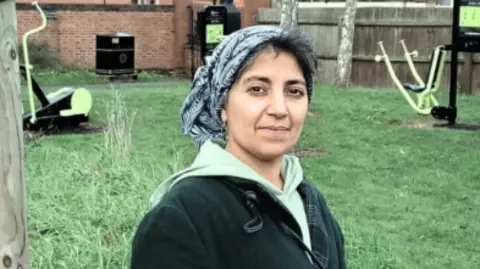 A woman in a headscarf in a park